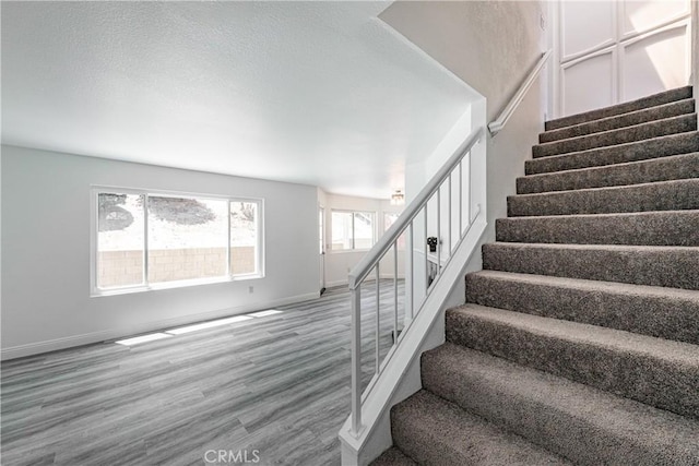 14791 Mountain High Dr, Fontana, CA 92337 - stairway with wood finished floors and baseboards