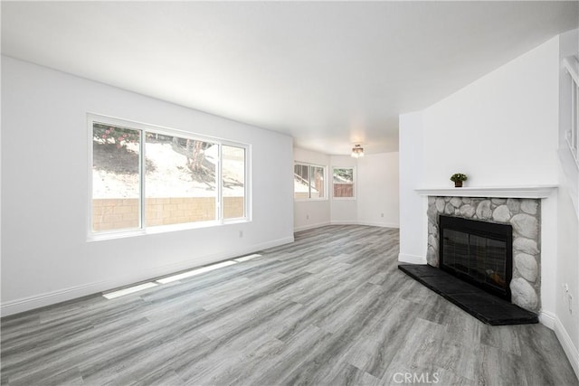 14791 Mountain High Dr, Fontana, CA 92337 - unfurnished living room with a stone fireplace and wood finished floors
