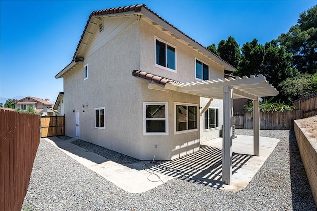 14791 Mountain High Dr, Fontana, CA 92337 - back of property featuring stucco siding, a pergola, a patio, and a fenced backyard