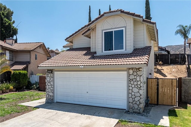 14791 Mountain High Dr, Fontana, CA 92337 - view of front facade with a tile roof, concrete driveway, and stone siding