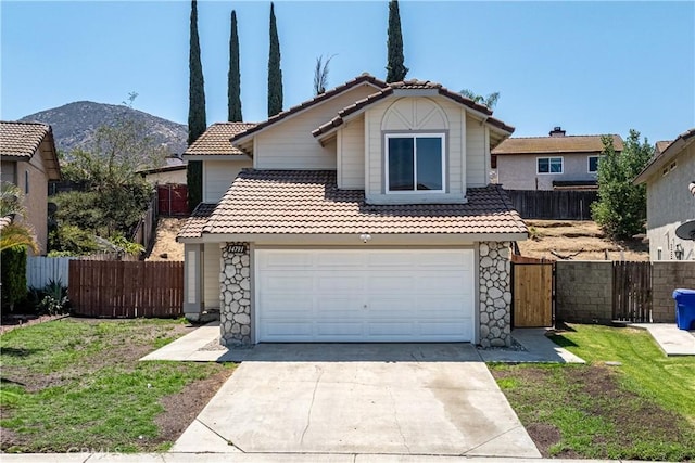 14791 Mountain High Dr, Fontana, CA 92337 - view of front of house with a tile roof, concrete driveway, stone siding, a garage, and a mountain view