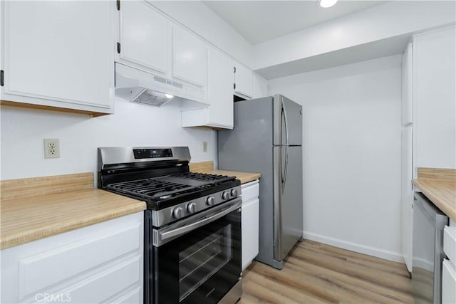 1119 Albany St Unit 226, Los Angeles, CA 90015 - kitchen featuring appliances with stainless steel finishes, under cabinet range hood, white cabinets, light countertops, and light wood-type flooring