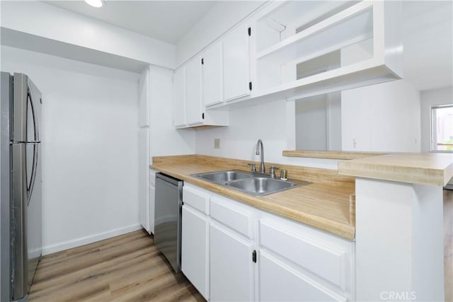 1119 Albany St Unit 226, Los Angeles, CA 90015 - kitchen with stainless steel appliances, white cabinets, light countertops, open shelves, and recessed lighting