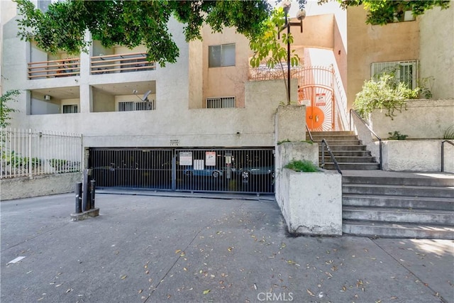 1119 Albany St Unit 226, Los Angeles, CA 90015 - view of property featuring driveway and a garage