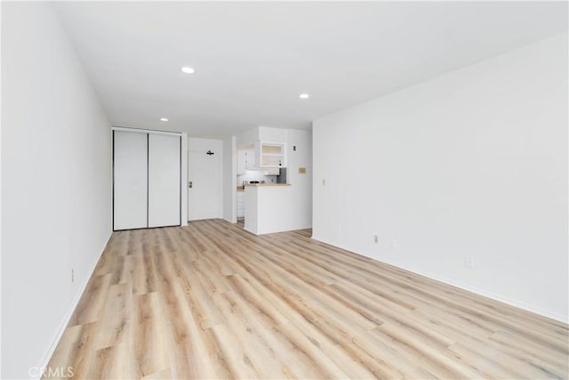 1119 Albany St Unit 226, Los Angeles, CA 90015 - unfurnished living room with light wood-style floors and recessed lighting