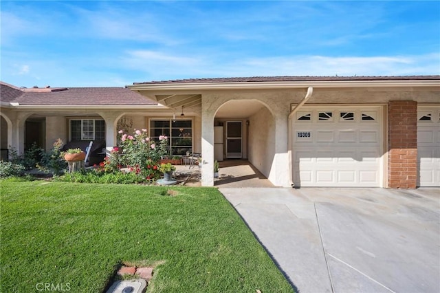 19309 Flowers Ct, Newhall, CA 91321 - view of front of home featuring driveway, a front lawn, an attached garage, and stucco siding