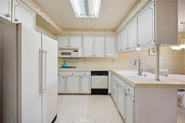 19309 Flowers Ct, Newhall, CA 91321 - kitchen featuring white appliances, tile counters, tasteful backsplash, and light flooring