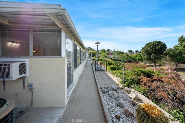 19309 Flowers Ct, Newhall, CA 91321 - view of side of property with concrete block siding and a sunroom
