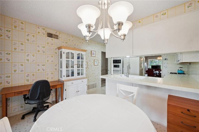 19309 Flowers Ct, Newhall, CA 91321 - dining room featuring a chandelier, wallpapered walls, and a desk
