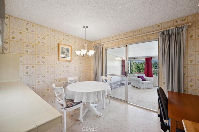 19309 Flowers Ct, Newhall, CA 91321 - dining space with a chandelier, a textured ceiling, and wallpapered walls