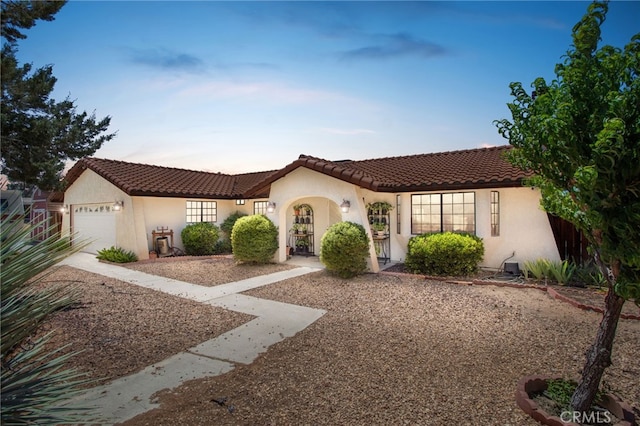 7390 Chase Ave, Hesperia, CA 92345 - mediterranean / spanish-style house with a garage, stucco siding, a tiled roof, and driveway