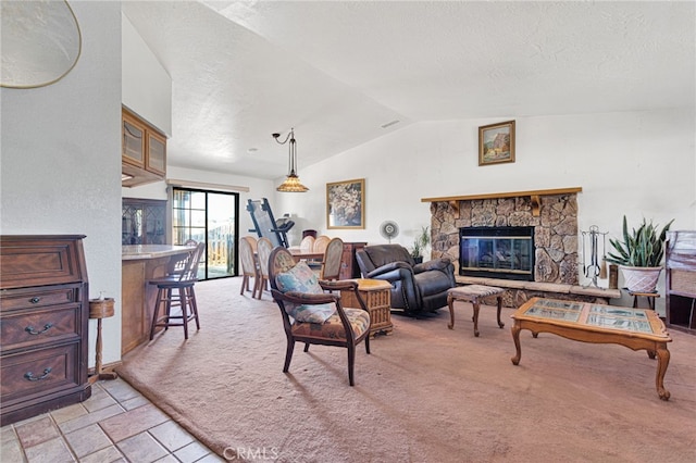 7390 Chase Ave, Hesperia, CA 92345 - living room with vaulted ceiling, light carpet, a stone fireplace, and a textured ceiling