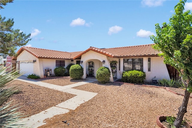 7390 Chase Ave, Hesperia, CA 92345 - mediterranean / spanish house with an attached garage, stucco siding, and a tiled roof