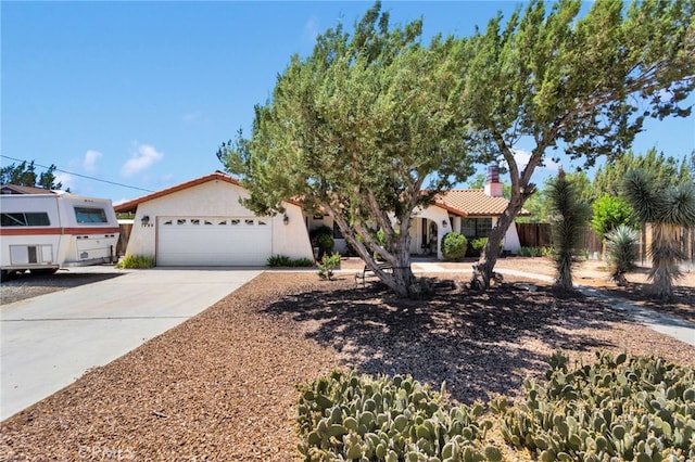 7390 Chase Ave, Hesperia, CA 92345 - mediterranean / spanish home featuring driveway, stucco siding, a tiled roof, and a chimney