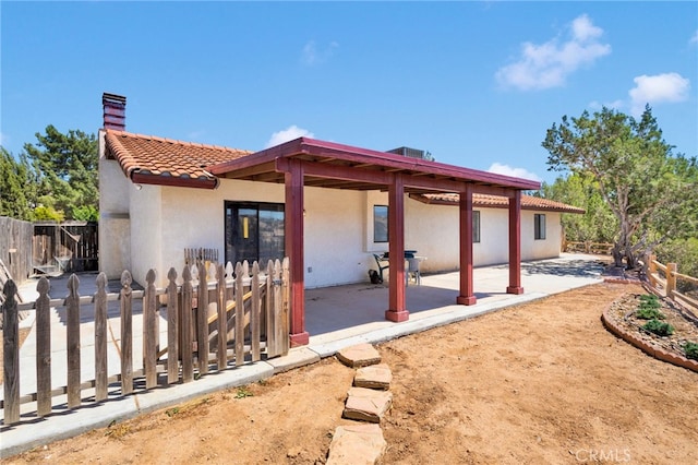 7390 Chase Ave, Hesperia, CA 92345 - rear view of property with stucco siding, a patio area, and a chimney