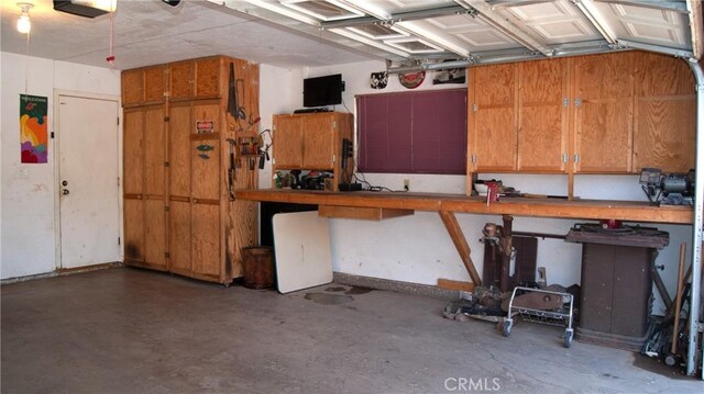 7390 Chase Ave, Hesperia, CA 92345 - garage featuring a workshop area and a garage door opener