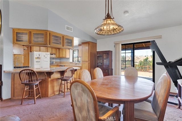 7390 Chase Ave, Hesperia, CA 92345 - dining area with light carpet, vaulted ceiling, and plenty of natural light