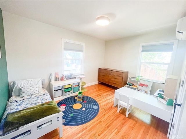 4574 Whaley Ave, Long Beach, CA 90807 - bedroom with multiple windows, wood finished floors, and a wall mounted air conditioner