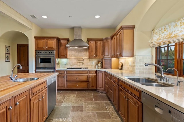 1559 Rolling Hills Rd, Santa Ynez, CA 93460 - kitchen featuring stainless steel appliances, wall chimney range hood, butcher block countertops, tasteful backsplash, and brown cabinets