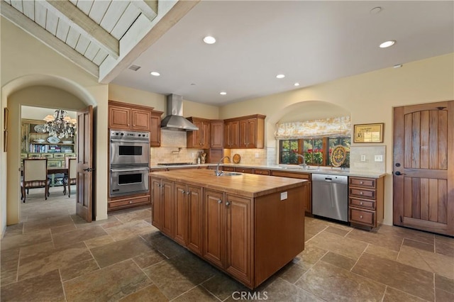 1559 Rolling Hills Rd, Santa Ynez, CA 93460 - kitchen featuring stainless steel appliances, wall chimney exhaust hood, a center island with sink, decorative backsplash, and recessed lighting