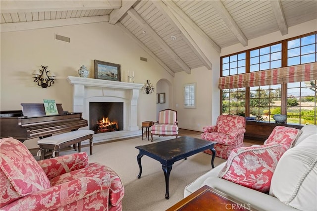 1559 Rolling Hills Rd, Santa Ynez, CA 93460 - carpeted living room featuring high vaulted ceiling, a warm lit fireplace, a wooden ceiling with exposed beams, and arched walkways