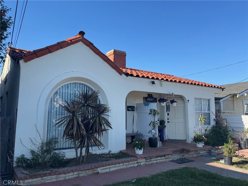 528530 W 19th St, San Pedro, CA 90731 - view of front of house with a chimney, stucco siding, and a tiled roof