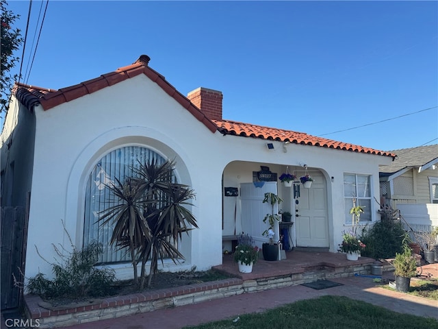 528530 W 19th St, San Pedro, CA 90731 - view of front of house with a chimney, stucco siding, and a tiled roof