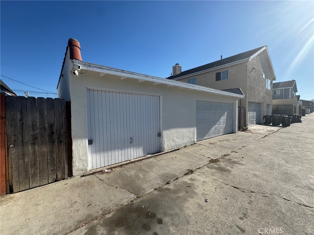 528530 W 19th St, San Pedro, CA 90731 - view of property exterior with stucco siding, a garage, and a chimney