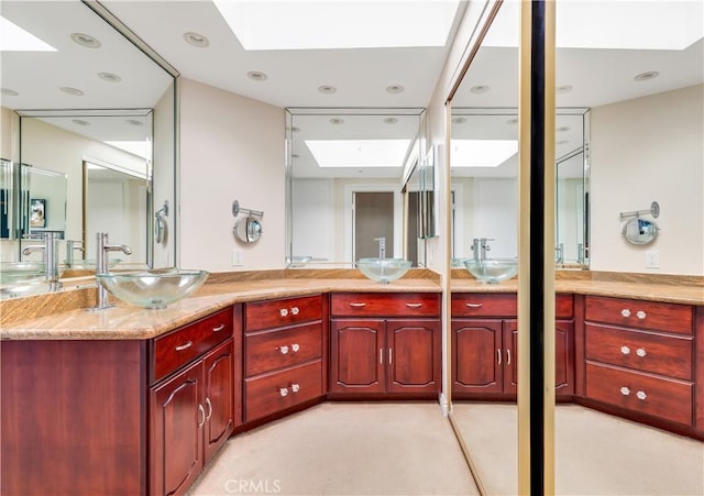 38 Canyon Island Dr Unit 38, Newport Beach, CA 92660 - bathroom with a skylight, double vanity, and recessed lighting