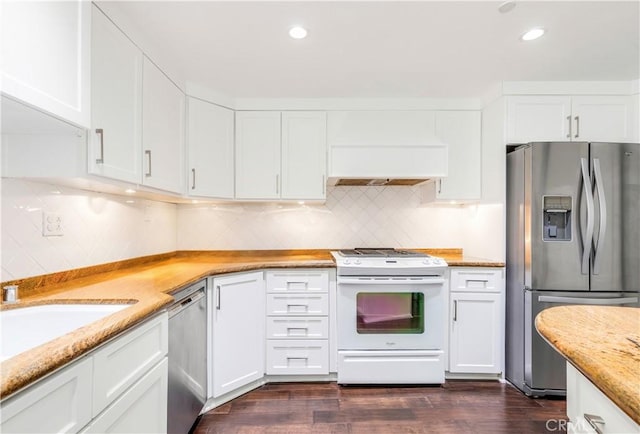 38 Canyon Island Dr Unit 38, Newport Beach, CA 92660 - kitchen with stainless steel appliances, custom exhaust hood, white cabinetry, backsplash, and recessed lighting