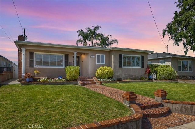 1372 W Sepulveda St, San Pedro, CA 90732 - view of front of home featuring stucco siding, a front lawn, and a chimney