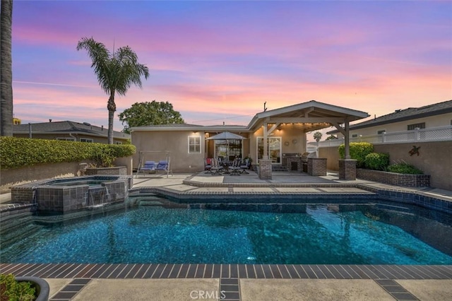 1372 W Sepulveda St, San Pedro, CA 90732 - pool at dusk with a patio, a pool with connected hot tub, and outdoor dining space
