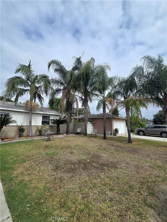 12431 Merrill St, Garden Grove, CA 92840 - view of home's exterior with an attached garage and a yard