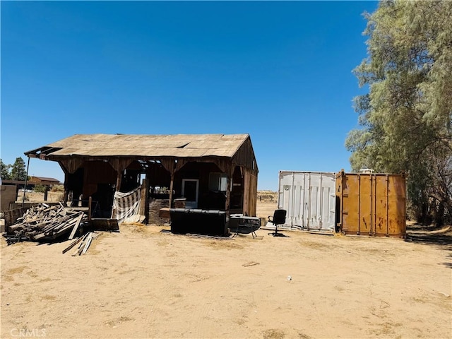 34756 Birch Rd, Barstow, CA 92311 - rear view of property with an outdoor structure and an exterior structure