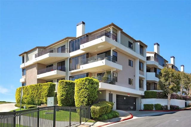 950 Cagney Ln Unit 107, Newport Beach, CA 92663 - view of apartment building / complex with a garage