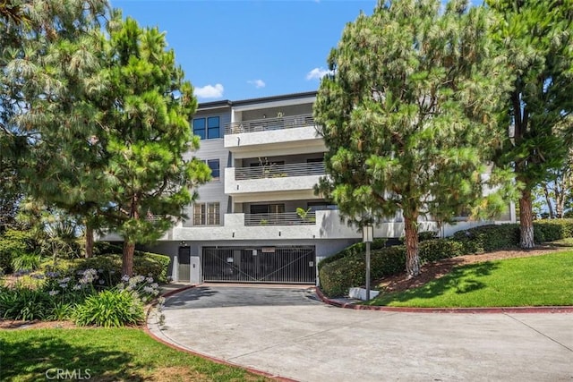 950 Cagney Ln Unit 107, Newport Beach, CA 92663 - view of property featuring concrete driveway and an attached garage