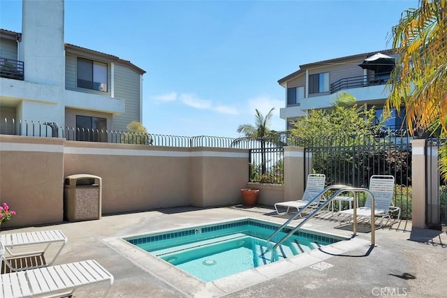 950 Cagney Ln Unit 107, Newport Beach, CA 92663 - view of swimming pool featuring a hot tub and a patio