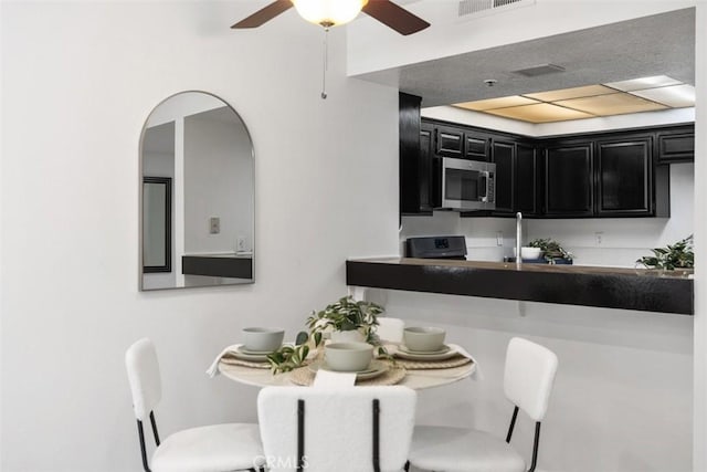 950 Cagney Ln Unit 107, Newport Beach, CA 92663 - dining area with ceiling fan