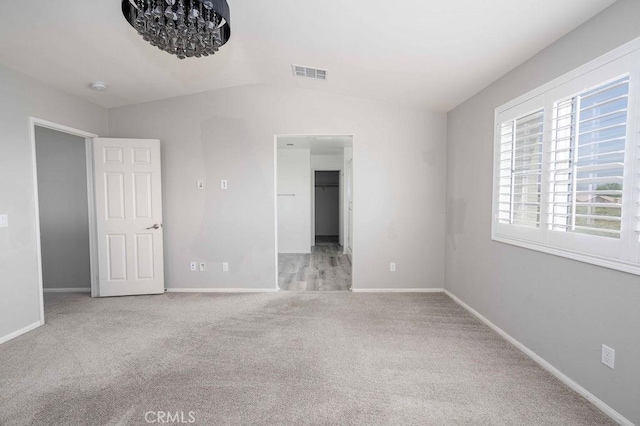 4389 Condor Ave, Fontana, CA 92336 - unfurnished bedroom with carpet, lofted ceiling, and a walk in closet