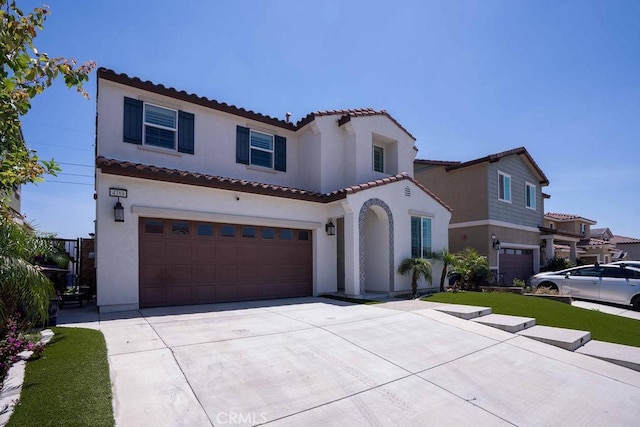 4389 Condor Ave, Fontana, CA 92336 - mediterranean / spanish house with a garage, stucco siding, and a tiled roof