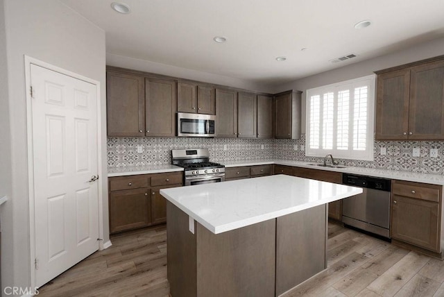 4389 Condor Ave, Fontana, CA 92336 - kitchen featuring stainless steel appliances, light wood-type flooring, light countertops, tasteful backsplash, and recessed lighting