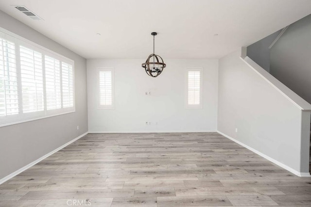 4389 Condor Ave, Fontana, CA 92336 - unfurnished dining area with plenty of natural light, a chandelier, and wood finished floors