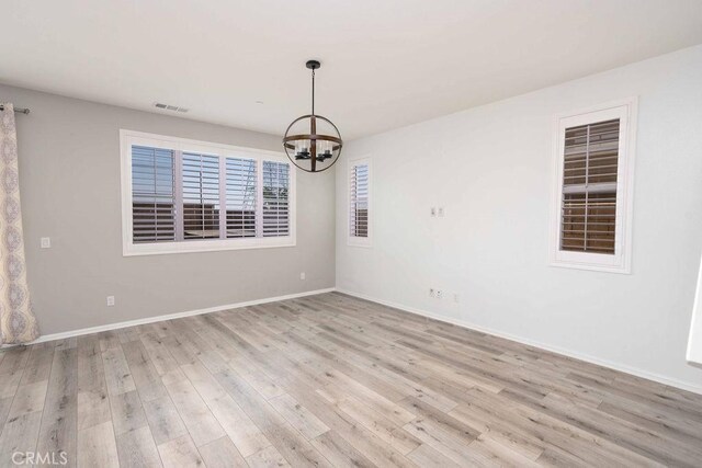 4389 Condor Ave, Fontana, CA 92336 - unfurnished room with a chandelier and light wood-type flooring