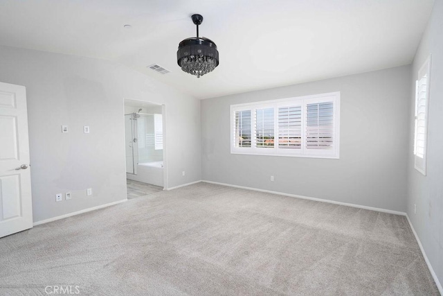4389 Condor Ave, Fontana, CA 92336 - empty room with healthy amount of natural light, light colored carpet, and vaulted ceiling