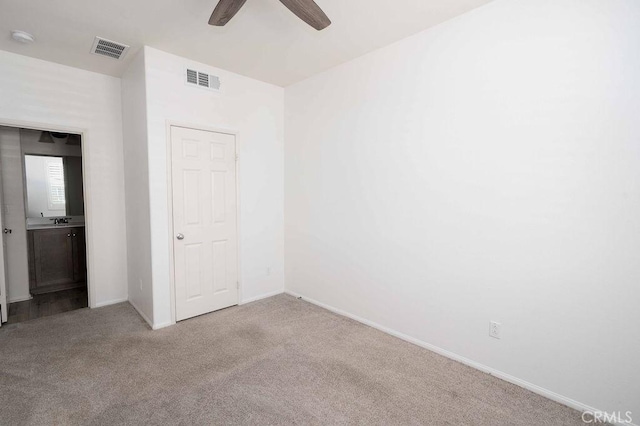 4389 Condor Ave, Fontana, CA 92336 - unfurnished bedroom with carpet floors, ceiling fan, and ensuite bathroom