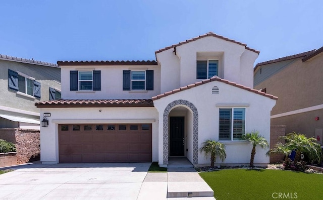 4389 Condor Ave, Fontana, CA 92336 - mediterranean / spanish home featuring an attached garage, driveway, stucco siding, and a tiled roof