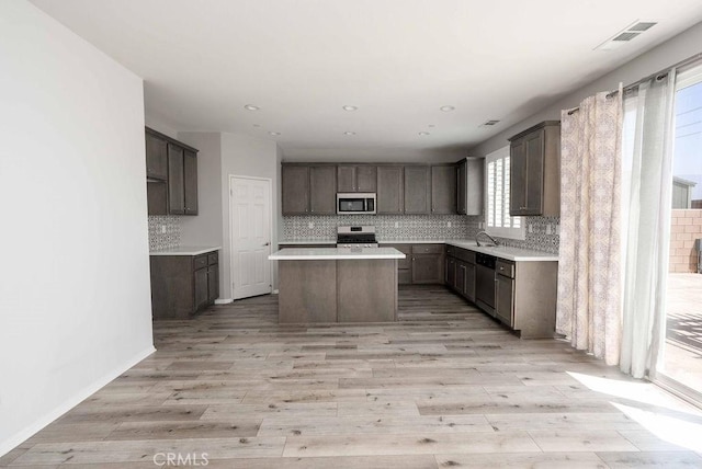 4389 Condor Ave, Fontana, CA 92336 - kitchen featuring appliances with stainless steel finishes, a kitchen island, tasteful backsplash, light countertops, and recessed lighting