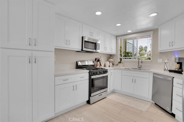 12 Sparrow Hill Ln, Laguna Hills, CA 92653 - kitchen with appliances with stainless steel finishes, light countertops, recessed lighting, white cabinets, and a textured ceiling