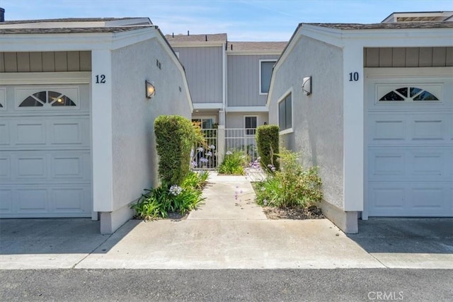 12 Sparrow Hill Ln, Laguna Hills, CA 92653 - doorway to property with stucco siding and a garage