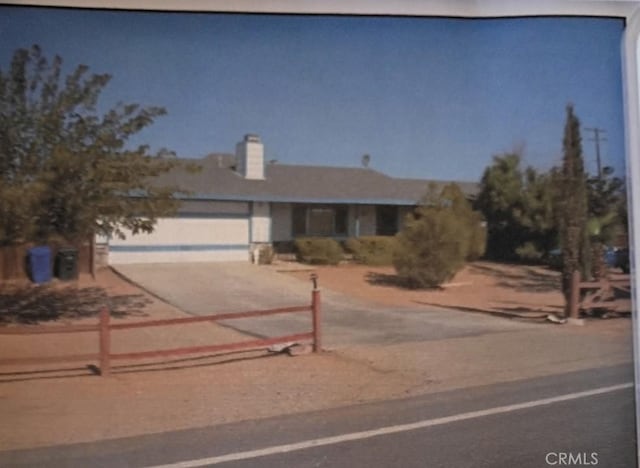 16082 Aztec Rd, Apple Valley, CA 92307 - view of front facade with driveway, an attached garage, and a chimney